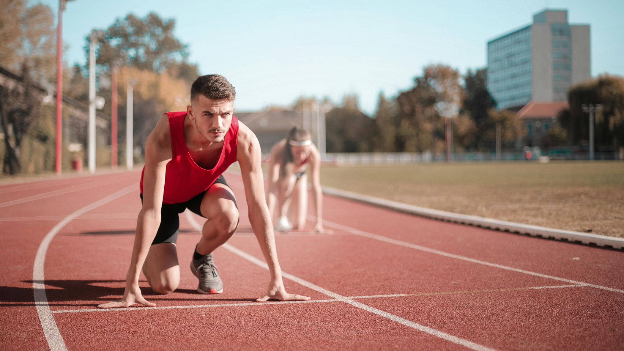 Distance Runners lining up on a track to run a race